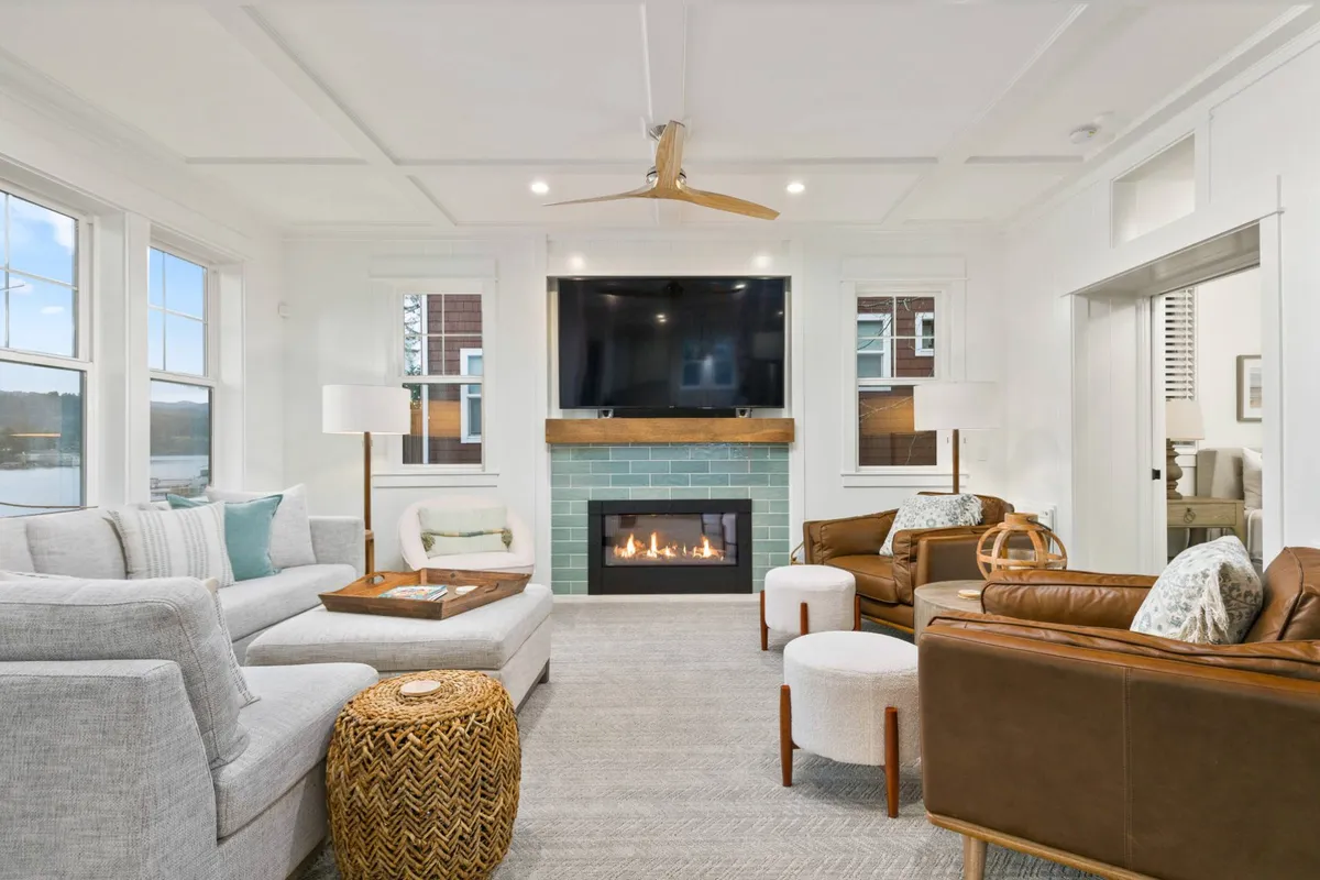 A welcoming living room featuring a plush sofa arrangement, a modern gas fireplace, and a smart TV. The layout encourages relaxation, socializing, and entertainment—exactly as described in the section’s narrative.